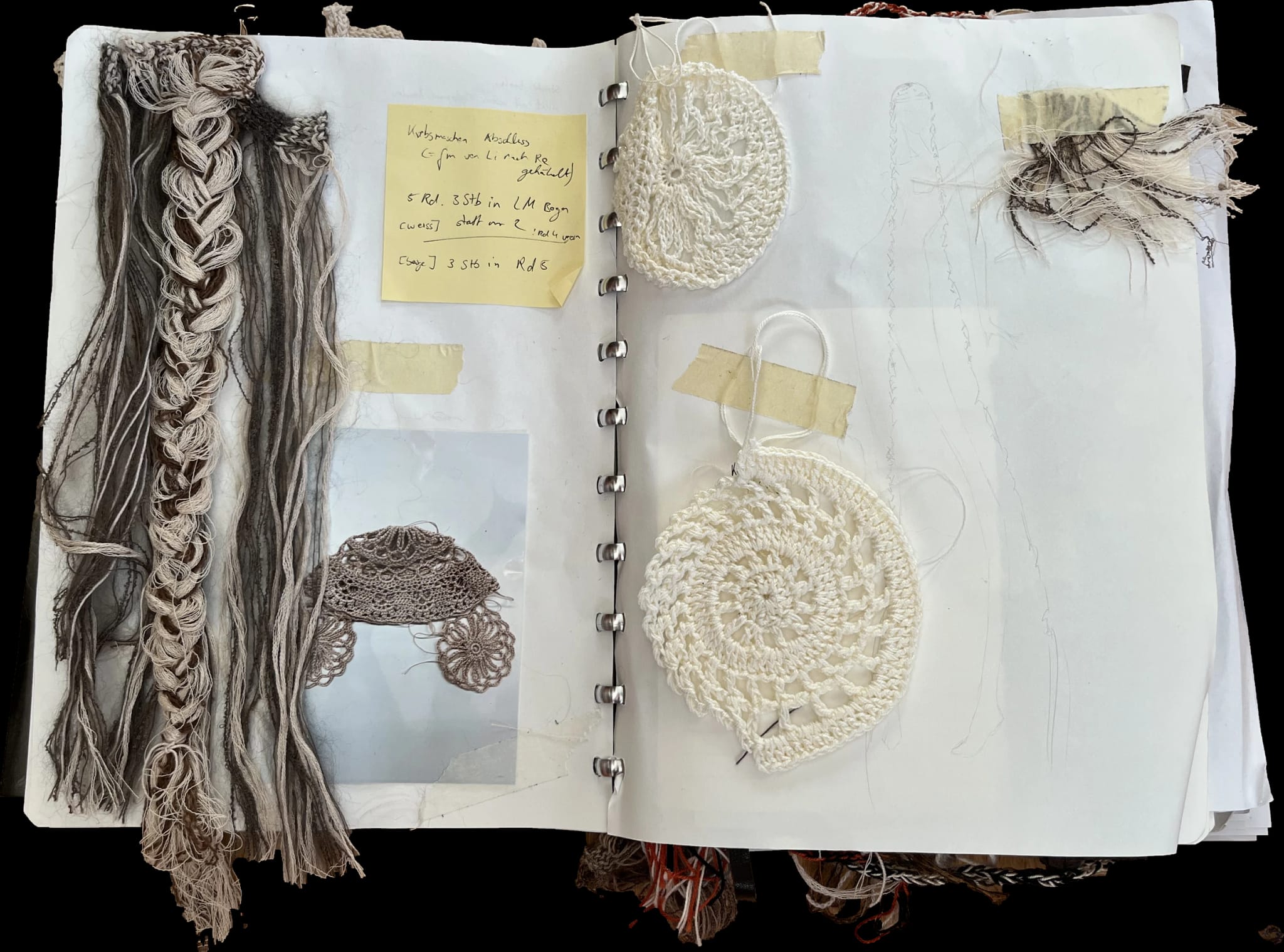Open sketchbook with braided yarn samples and crocheted circles